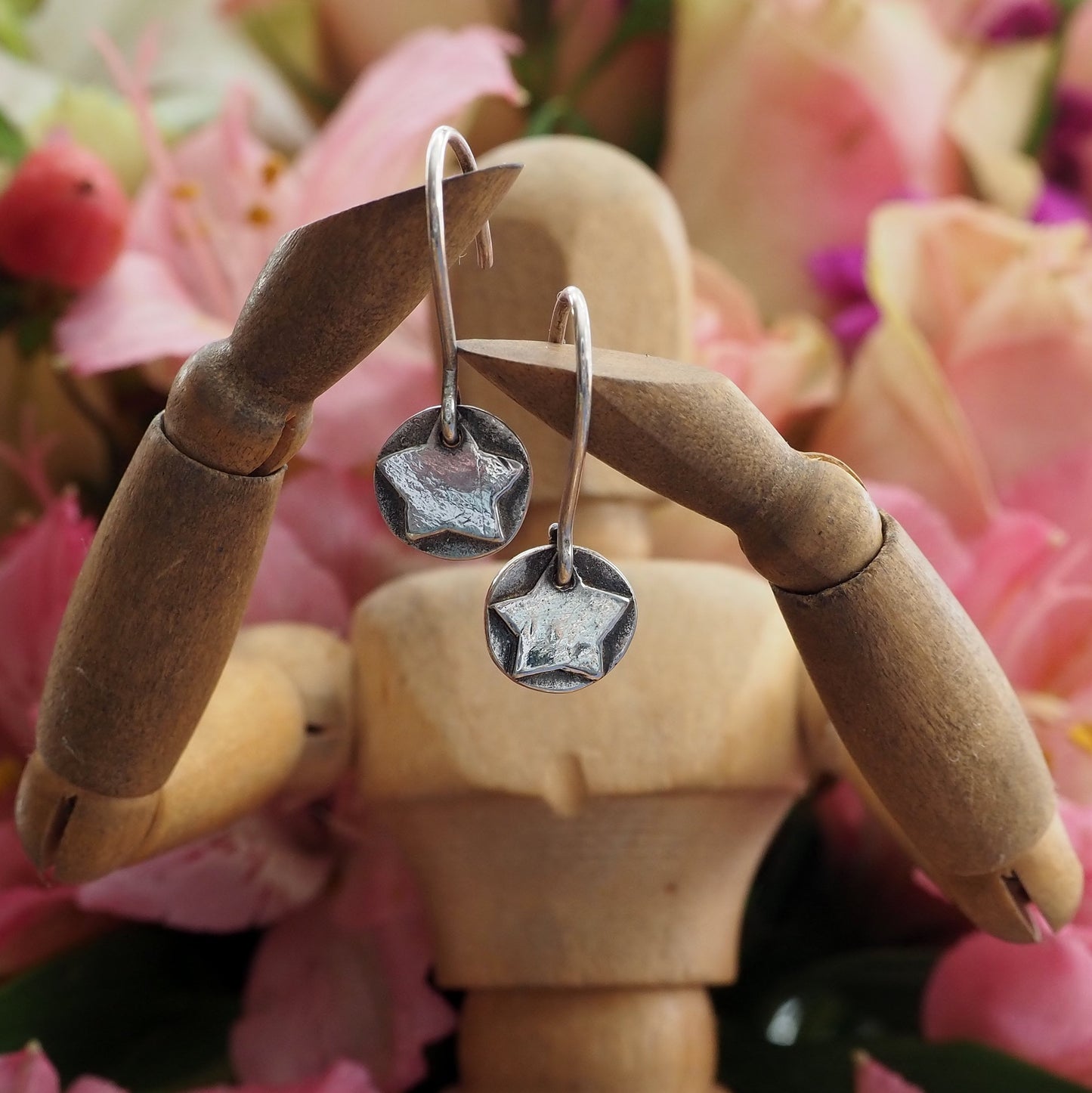 A gorgeously pair of dainty silver hand made star earrings.