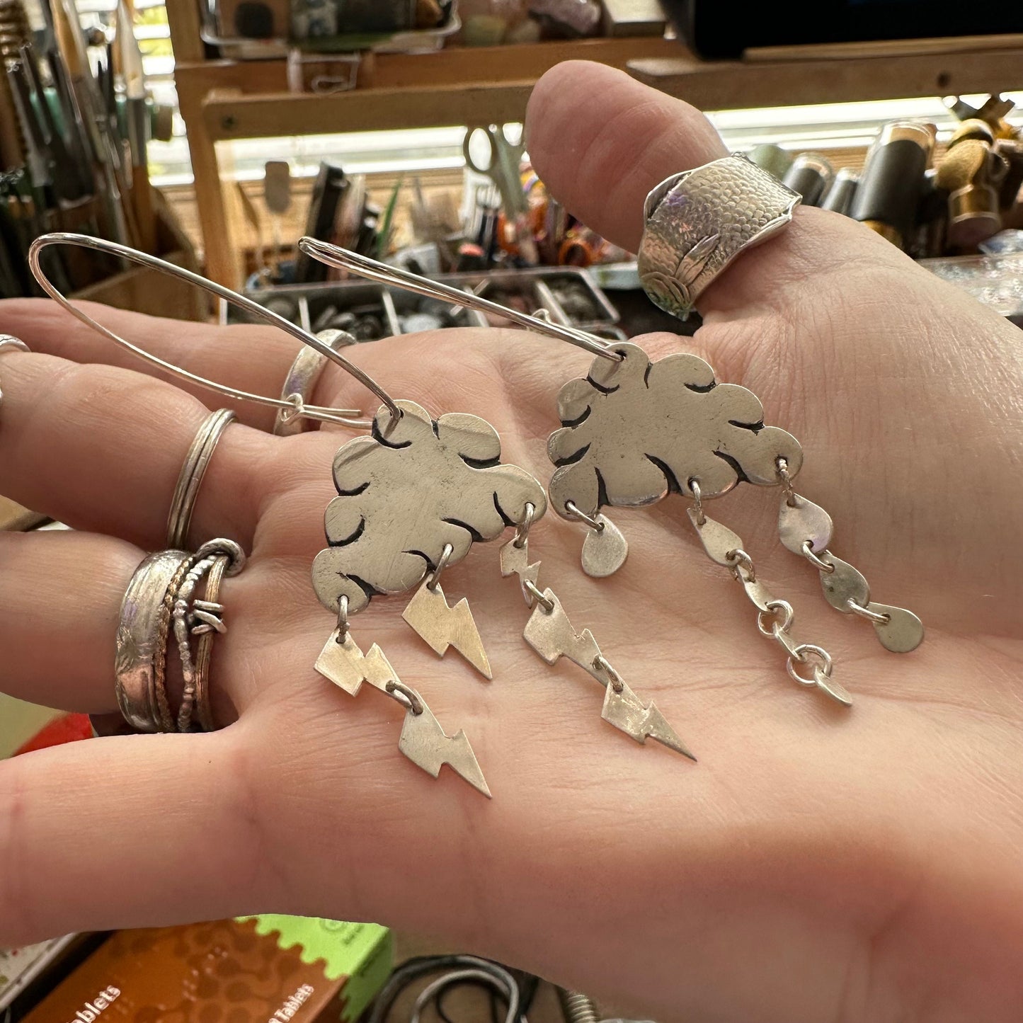 A gorgeous pair of cloudy weather earrings handmade in fine silver and hung on large handmade sterling silver hoops.