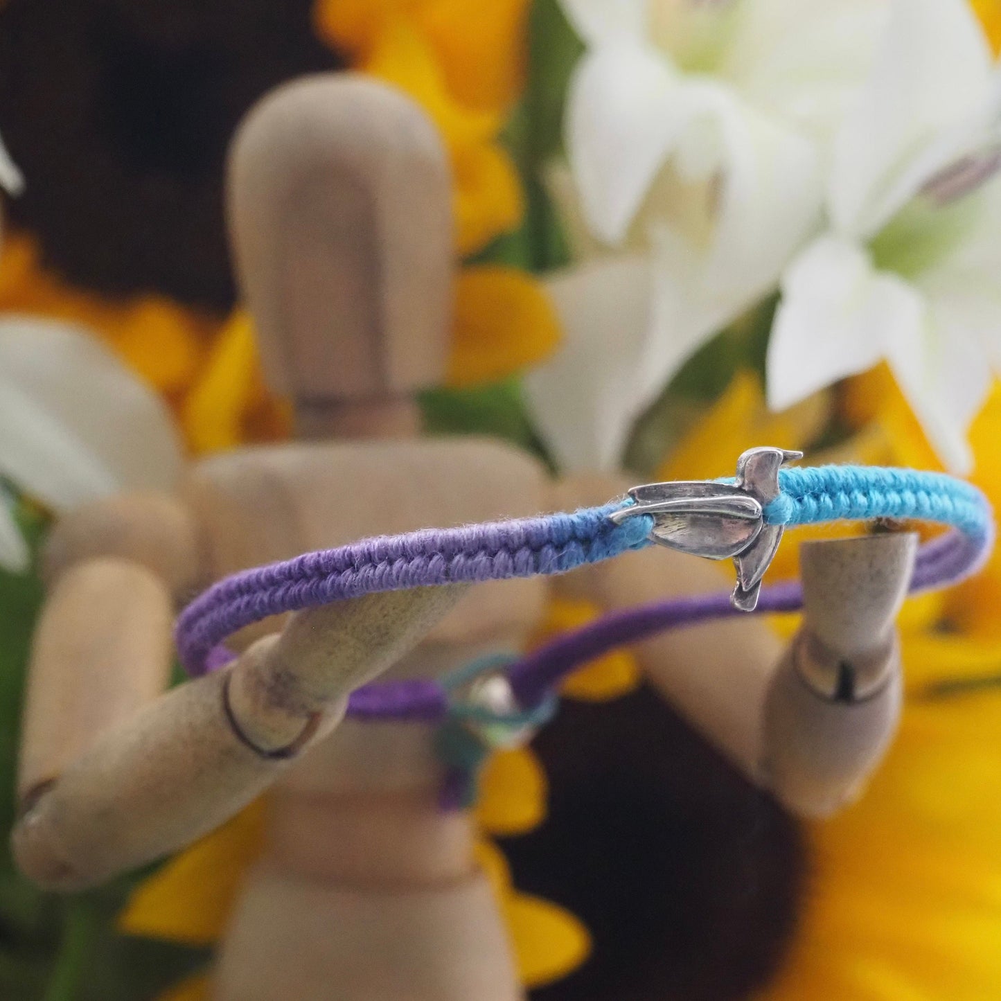 A lovely fine silver humming bird on a cute purple and turquoise leather, sterling silver and cotton friendship bracelet.