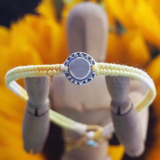 A beaming sun handmade in fine silver on a gorgeous yellow, orange, friendship bracelet in leather, cotton and sterling silver.