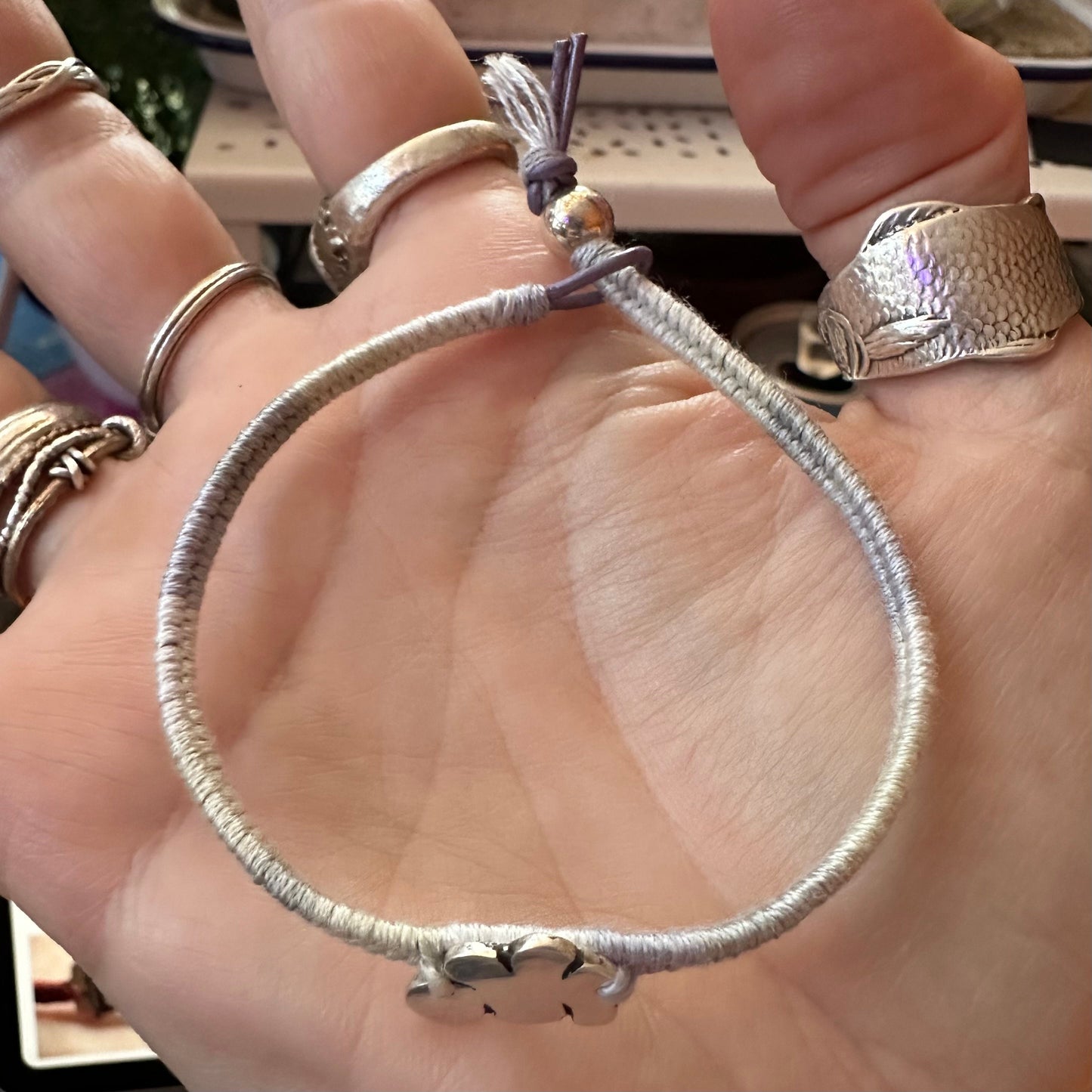 A gorgeous little cloud charm hand made in fine silver on a soft grey leather, cotton and sterling silver friendship bracelet.