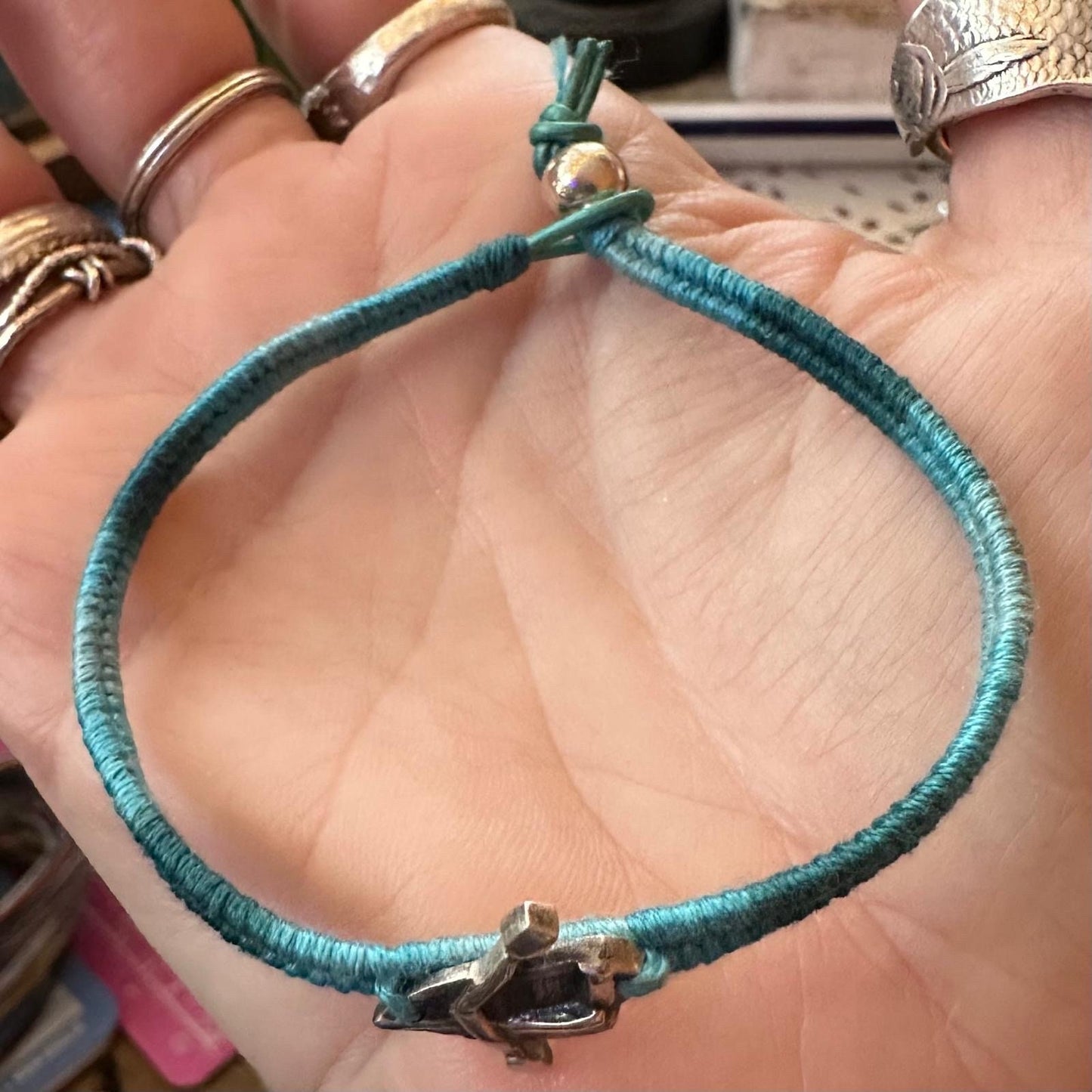 A lovely tiny unique fine silver rowing boat on a gorgeous soft blue leather, cotton and sterling silver friendship bracelet.