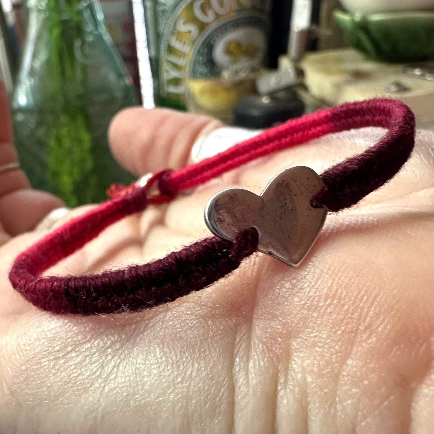 A fabulously blood red leather, sterling silver and cotton friendship bracelet with a tiny unique fine silver heart.