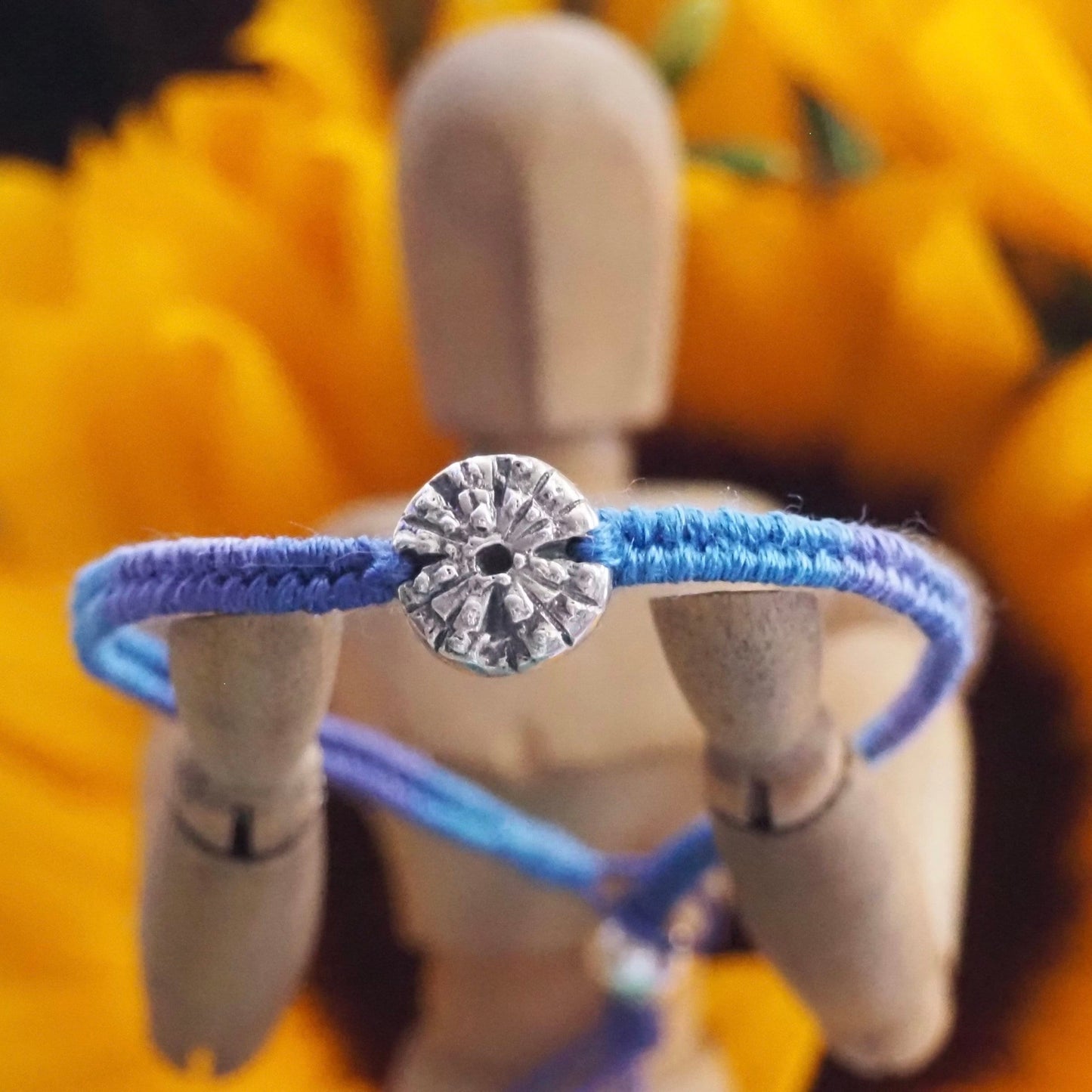 A gorgeous deep blue leather, cotton and sterling silver friendship bracelet with a lovely handmade fine silver sea urchin .