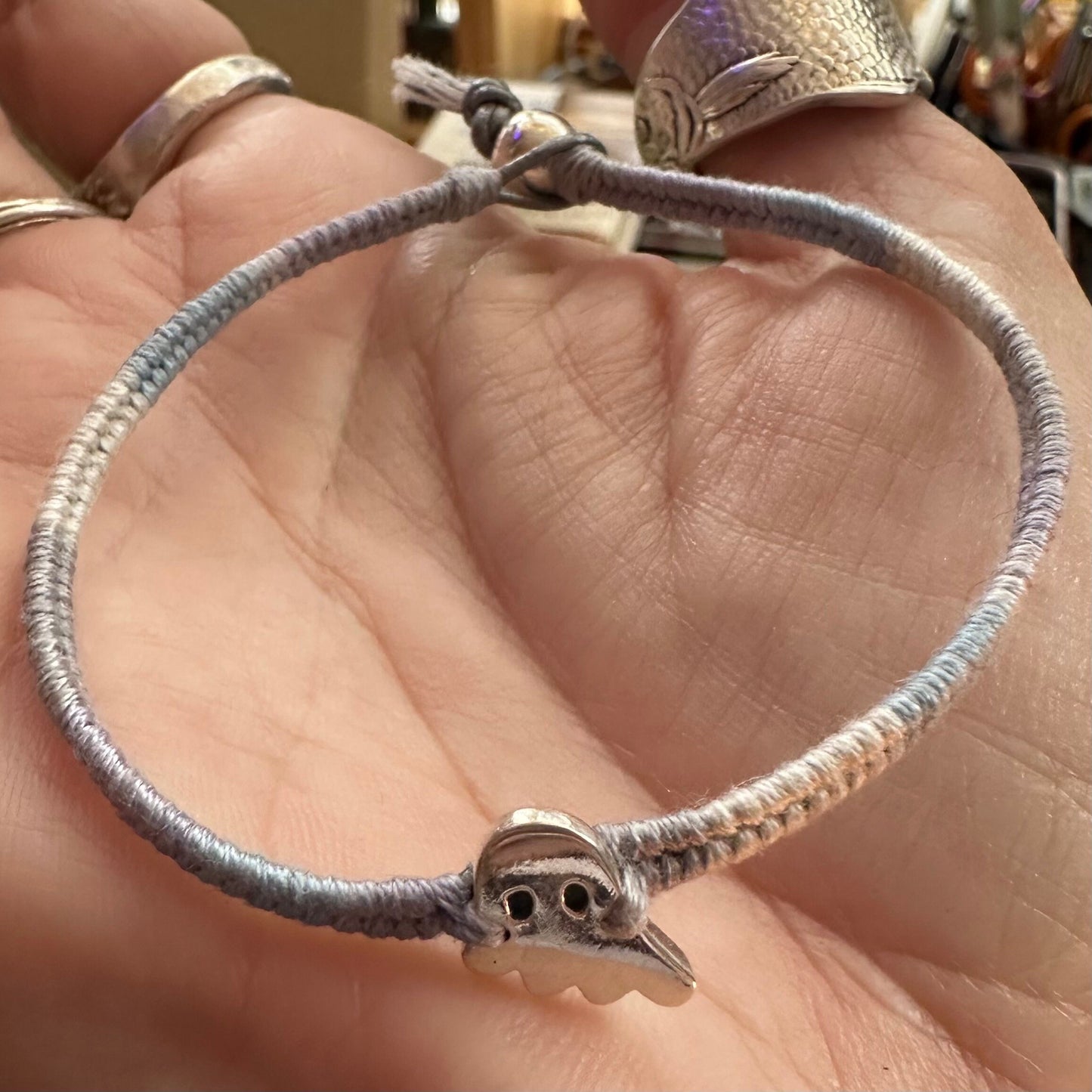 A gorgeous little ghost charm hand made in fine silver on a soft grey leather, cotton and sterling silver friendship bracelet.