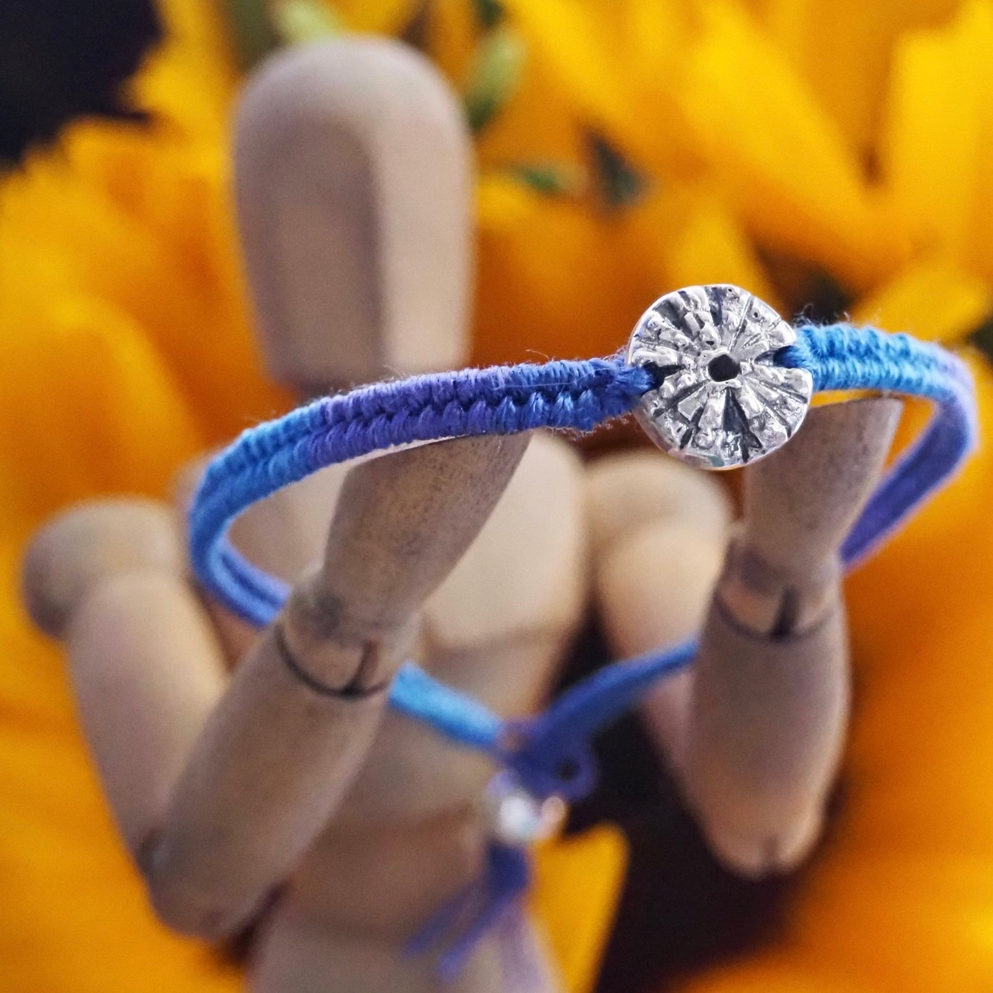 A gorgeous deep blue leather, cotton and sterling silver friendship bracelet with a lovely handmade fine silver sea urchin .