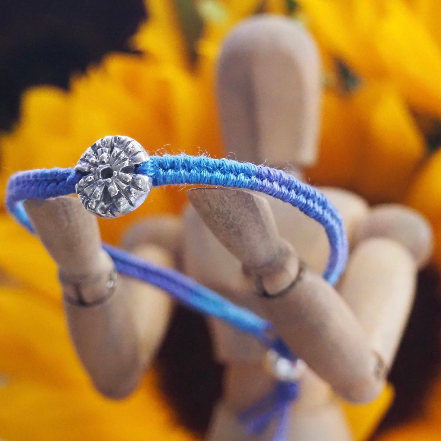 A gorgeous deep blue leather, cotton and sterling silver friendship bracelet with a lovely handmade fine silver sea urchin .