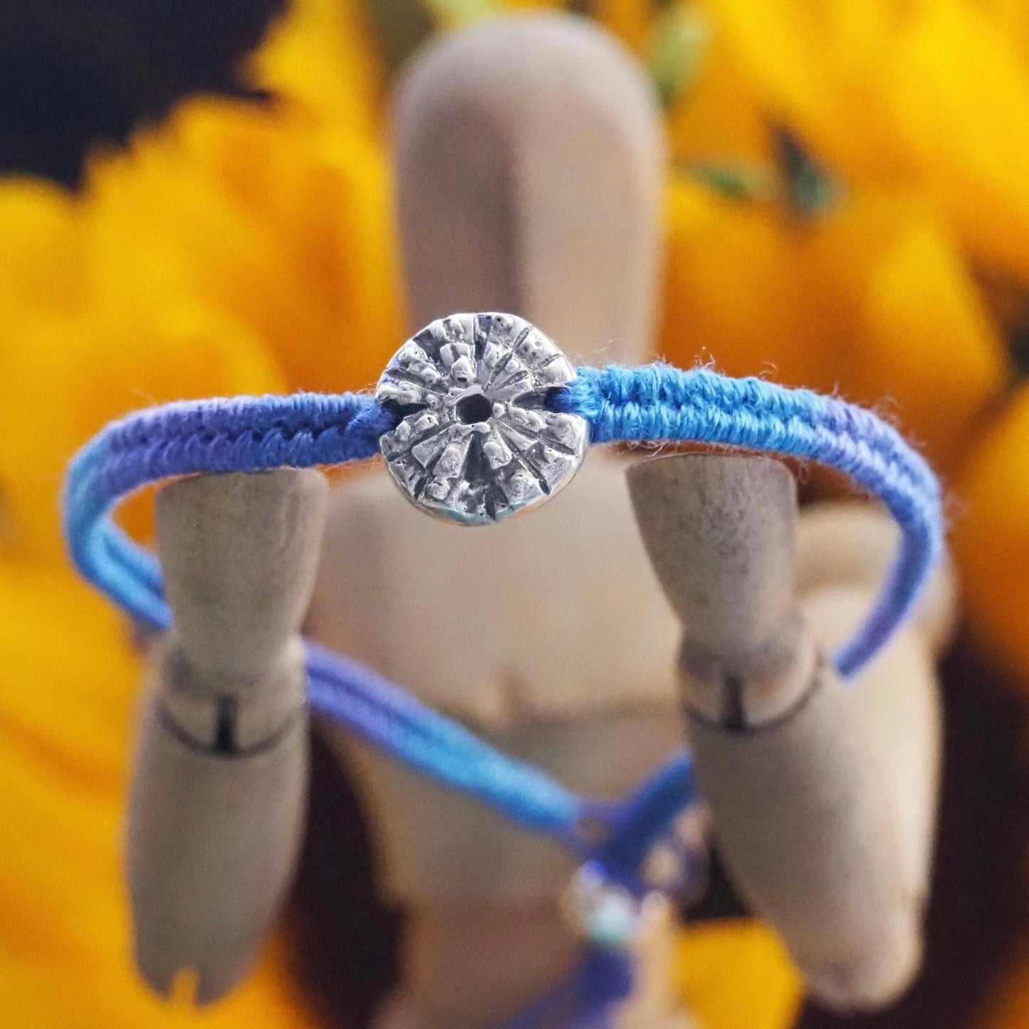 A gorgeous deep blue leather, cotton and sterling silver friendship bracelet with a lovely handmade fine silver sea urchin .