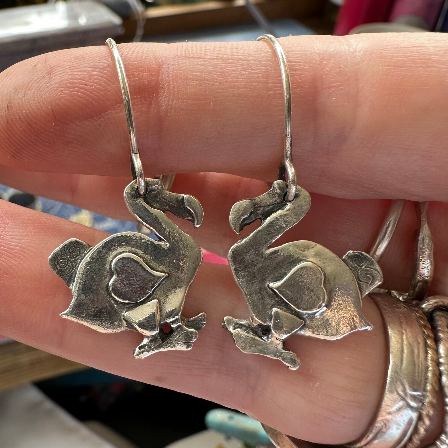A gorgeous pair of midsize handmade fine silver dodo earrings hung on sterling silver wires.