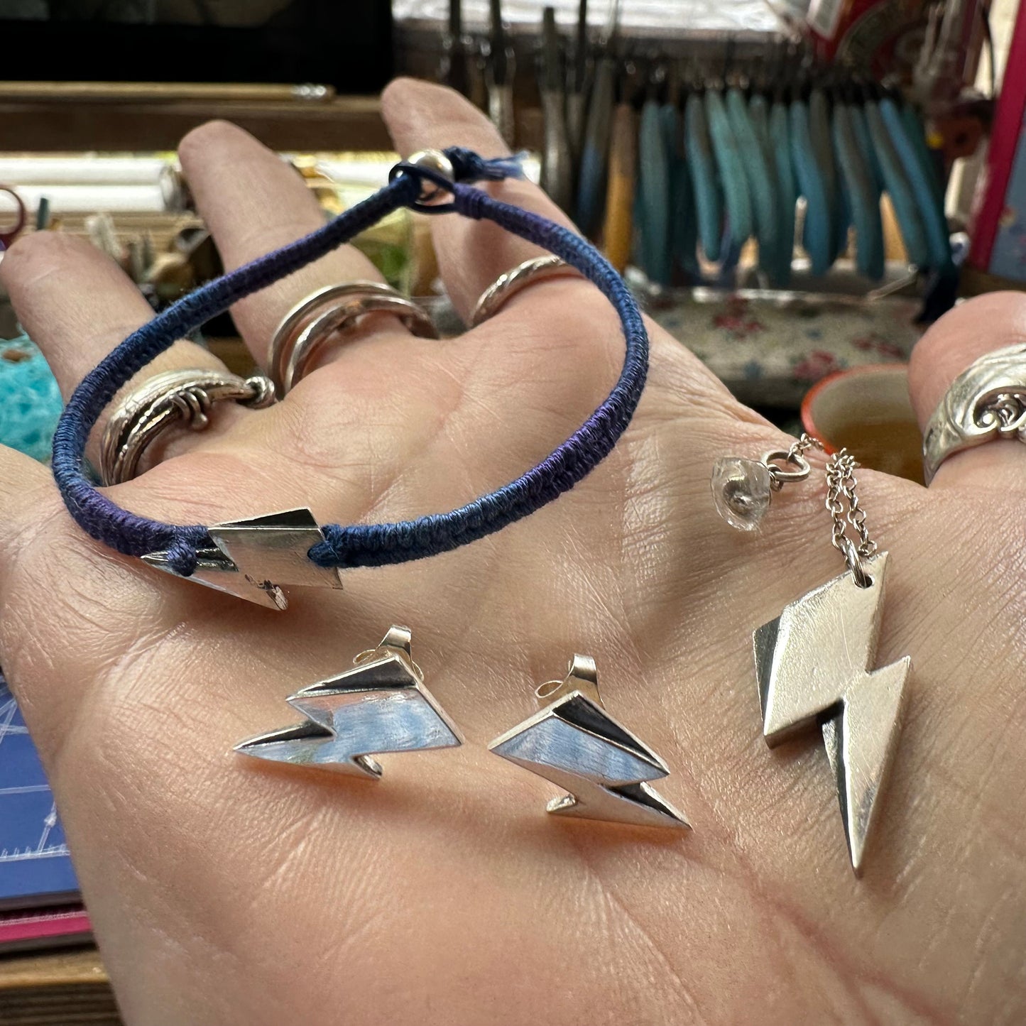 A beautiful simple lightning bolt pendant hand made in fine silver, hung on a sterling silver chain.