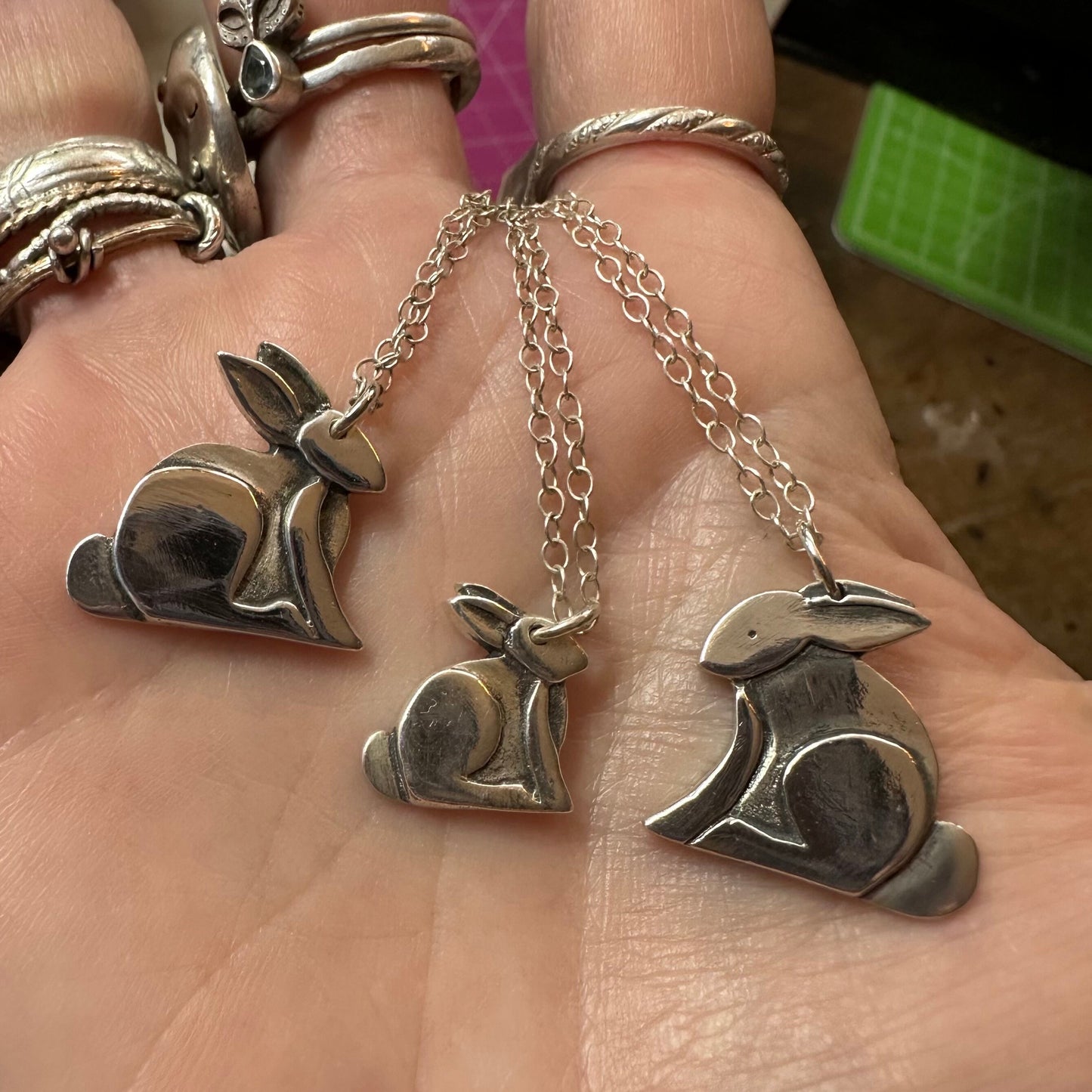 A beautiful tiny delicate handmade fine silver rabbit pendant on a sterling silver chain.