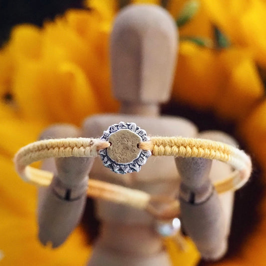A 24k gold centred sunflower handmade in fine silver on a gorgeous yellowy orange woven leather, cotton and sterling silver charm bracelet.