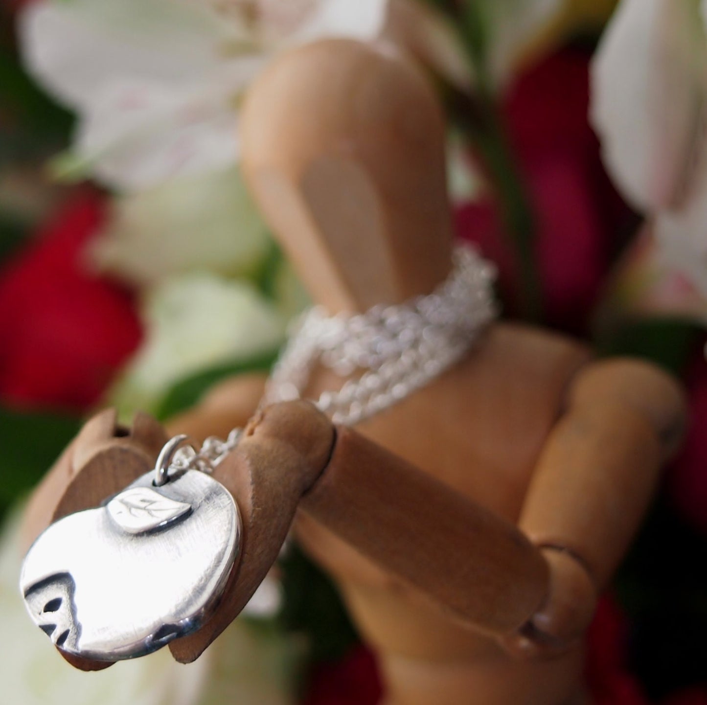 A Gothic Apple with a tiny skull motif handmade in solid silver. On a sterling silver chain, perfect for a Halloween teacher