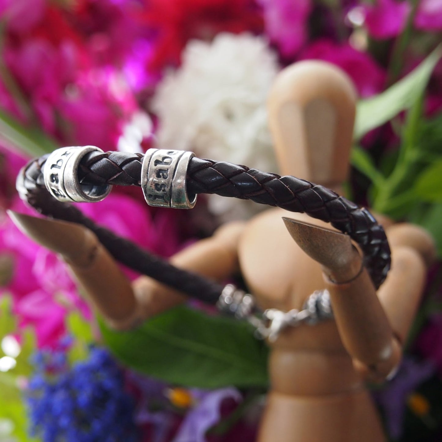 A lovely plaited leather charm bead bracelet. Little handmade personalised beads in silver clay with sterling silver clasp