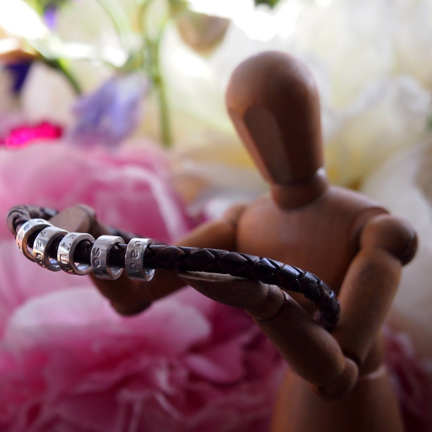 A lovely plaited leather charm bead bracelet. Tiny handmade personalised beads in sterling silver with sterling silver clasp