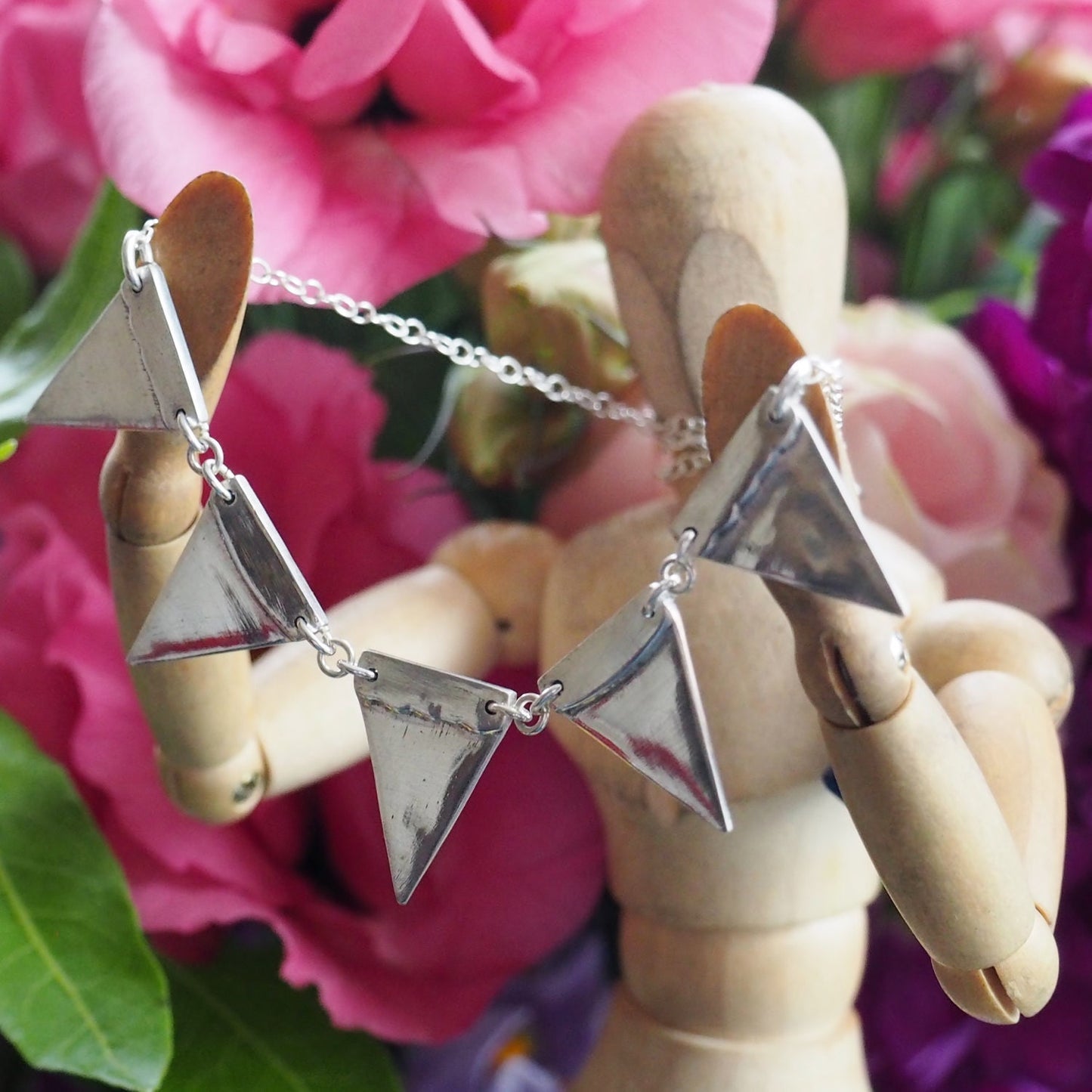 a beautiful fine silver bunting necklace strung on sterling silver chain