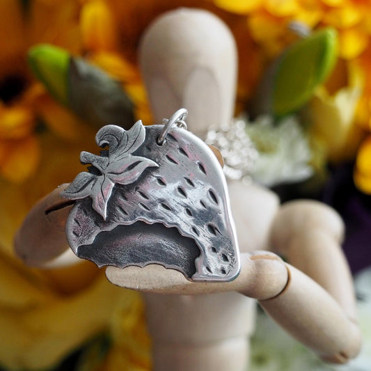 A pretty, simple fine silver strawberry on a long chunky sterling silver chain.