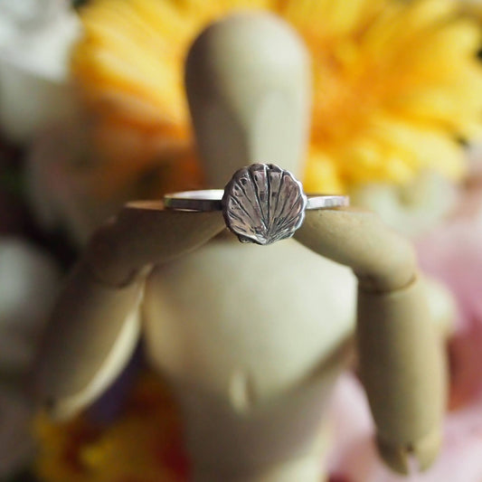 A super simple fine silver scallop shell on a square sterling silver ring.