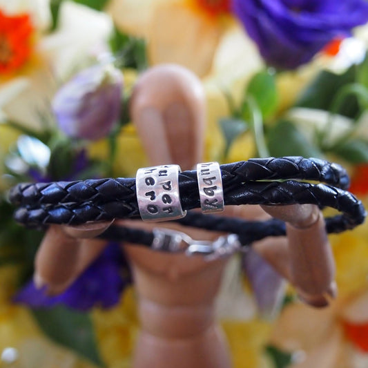 A lovely plaited leather charm bead bracelet. Handmade personalised beads in fine silver with sterling silver clasp