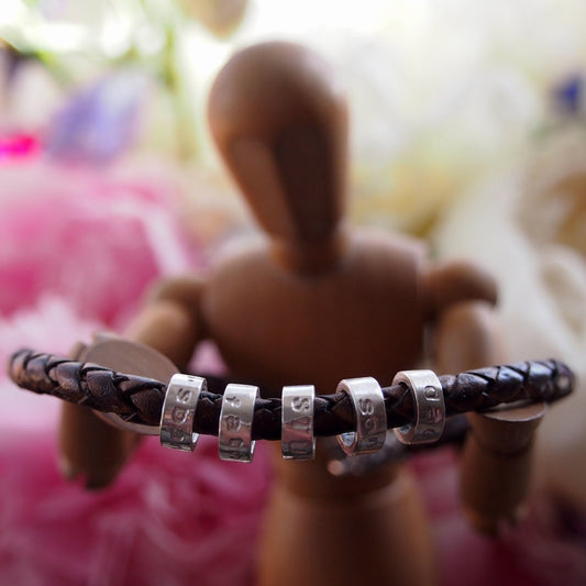 A lovely plaited leather charm bead bracelet. Tiny handmade personalised beads in sterling silver with sterling silver clasp