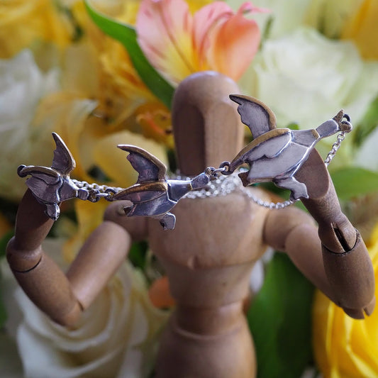 A beautiful set of handmade unique fine silver flying ducks with gold highlights, hung on sterling silver necklace. Hilda would love them