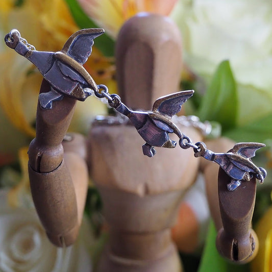 A gorgeous set of handmade unique fine silver flying ducks with gold highlights, hung on sterling silver necklace. Mrs Ogden would love them