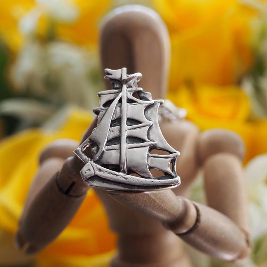 A gorgeous handmade fine silver two masted ship with beautifully detailed sails, a pendant on a long sterling silver chain.