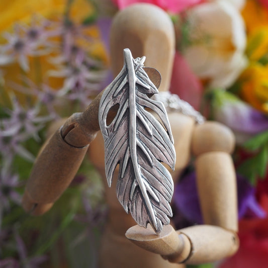 A gorgeous unique tropical banana leaf handmade in fine silver on a sterling silver necklace.