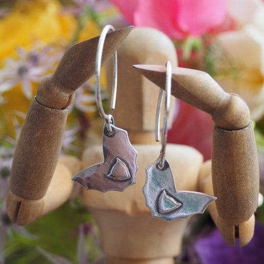 A pair of delightfully simple eco friendly fine silver bat earrings hung on handmade sterling silver wires.