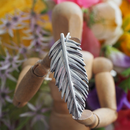 A beautiful unique tropical palm leaf handmade in eco friendly fine silver on a sterling silver necklace.