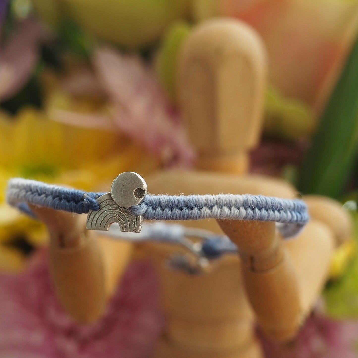 A gorgeous rainbow and moon hand made of fine silver on a small graduated blues leather, cotton and sterling silver friendship bracelet