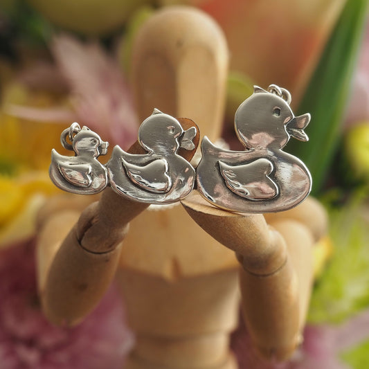 A gorgeous set of swimming rubber ducks, hand made in fine silver and hung on sterling silver chain