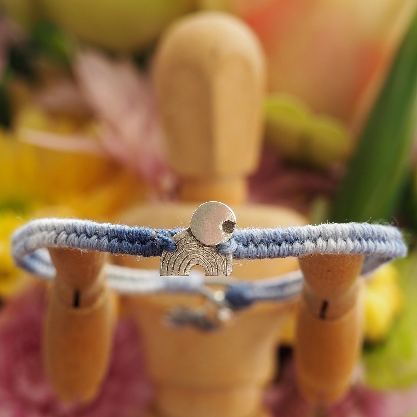 A gorgeous rainbow and moon hand made of fine silver on a small graduated blues leather, cotton and sterling silver friendship bracelet