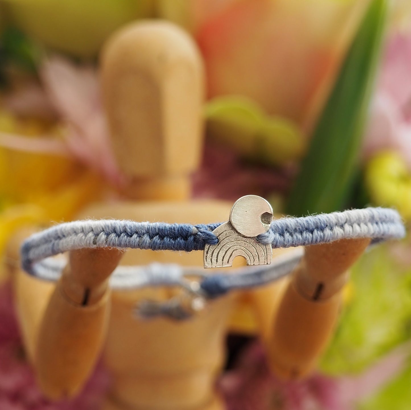 A gorgeous rainbow and moon hand made of fine silver on a small graduated blues leather, cotton and sterling silver friendship bracelet