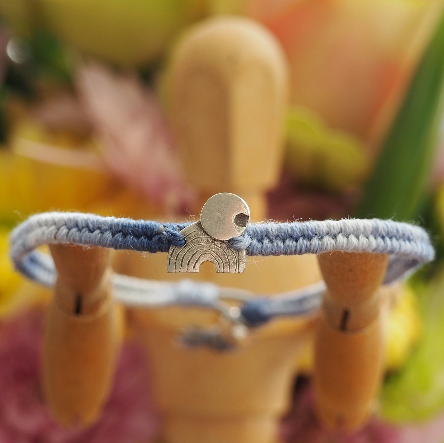 A gorgeous rainbow and moon hand made of fine silver on a small graduated blues leather, cotton and sterling silver friendship bracelet