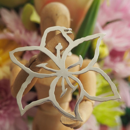 A stunning  unique lily flower pendant hand cut in recycled sterling silver on a sterling silver chain.