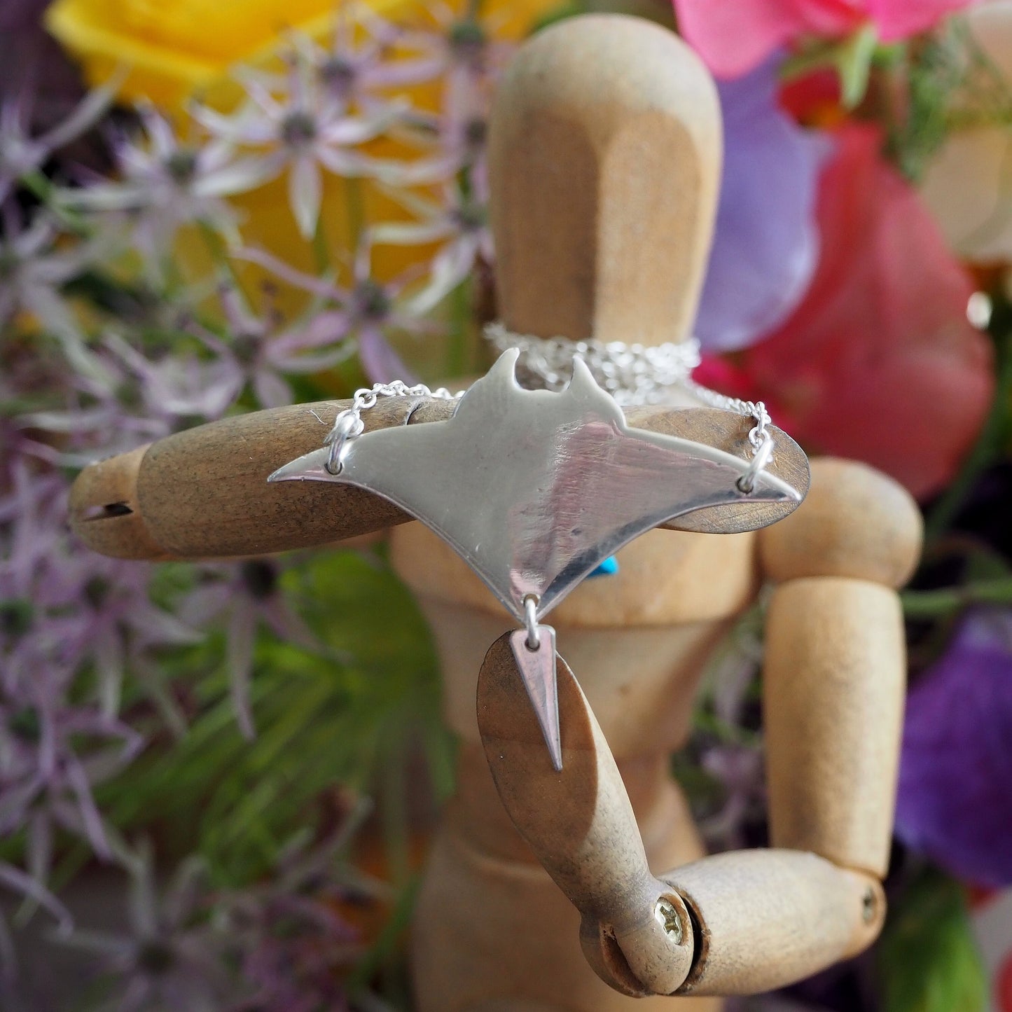 A perfectly simple manta ray handmade in fine silver pendant of a on a sterling silver chain.