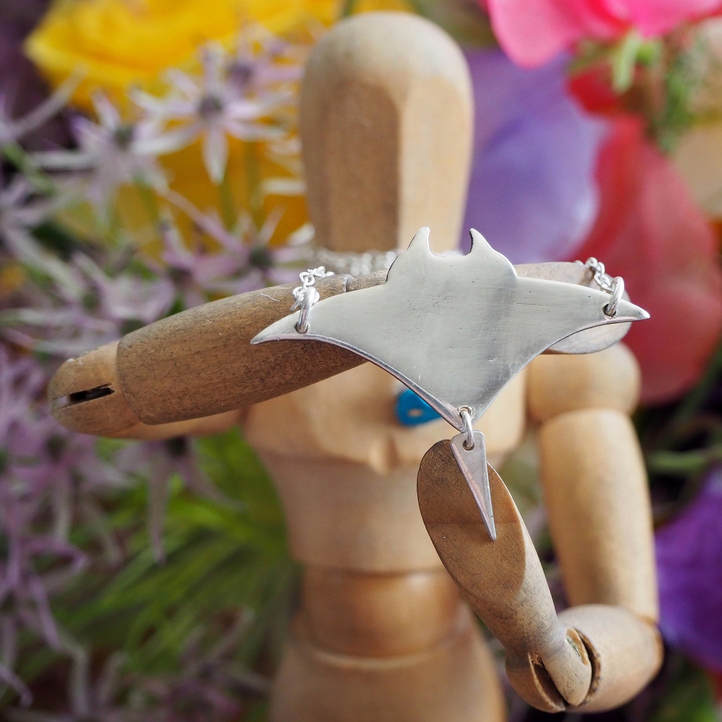 A perfectly simple manta ray handmade in fine silver pendant of a on a sterling silver chain.