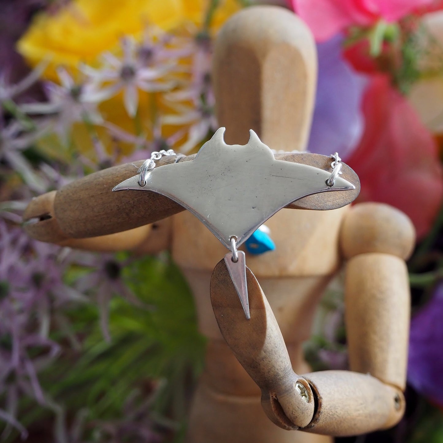 A perfectly simple manta ray handmade in fine silver pendant of a on a sterling silver chain.