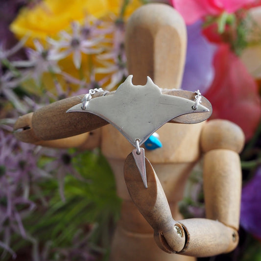 A perfectly simple manta ray handmade in fine silver pendant of a on a sterling silver chain.