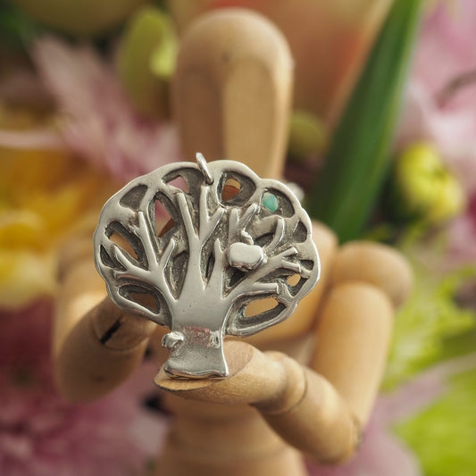 A gorgeous apple tree handmade in fine silver hung on a sterling silver chain.