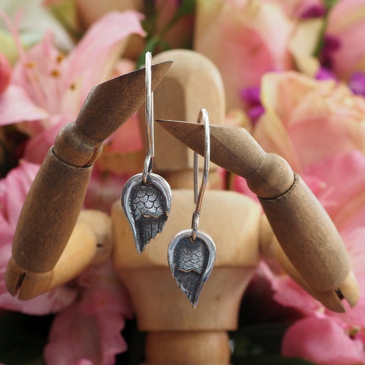 A gorgeous little pair of fine silver angel wing earrings hung on handmade sterling silver loops.