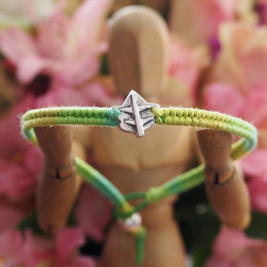 A delightful handmade fine silver ivy leaf on a shades of green friendship bracelet in leather, sterling silver and cotton.