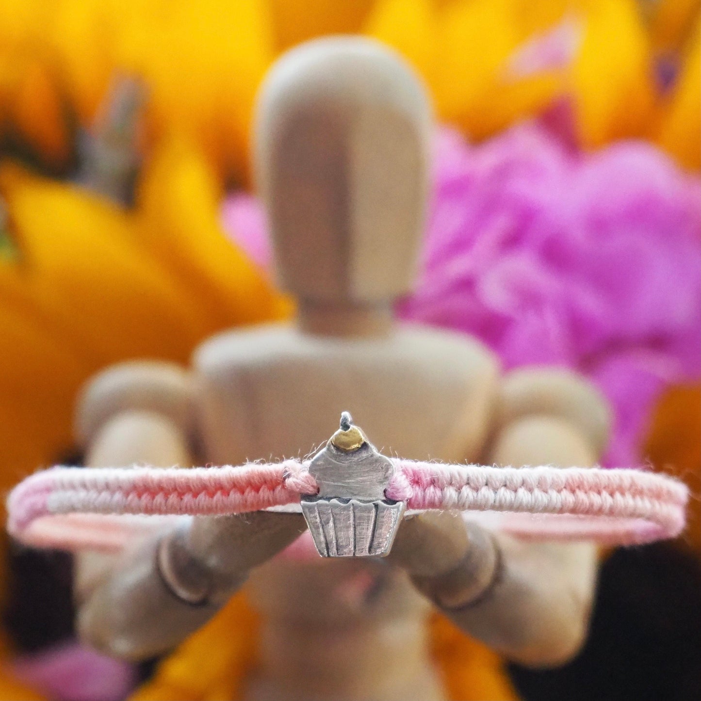 A beautiful pinky leather, cotton and sterling silver friendship bracelet with a lovely fine silver cupcake topped with a 24k gold cherry.