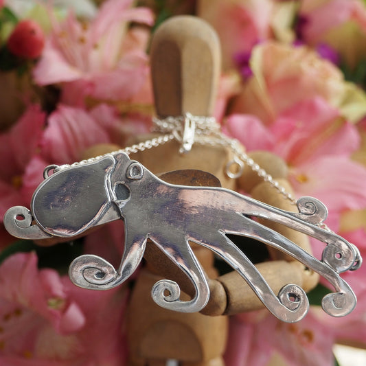 A beautiful unique hand made giant octopus fine silver pendant on a sterling silver chain.