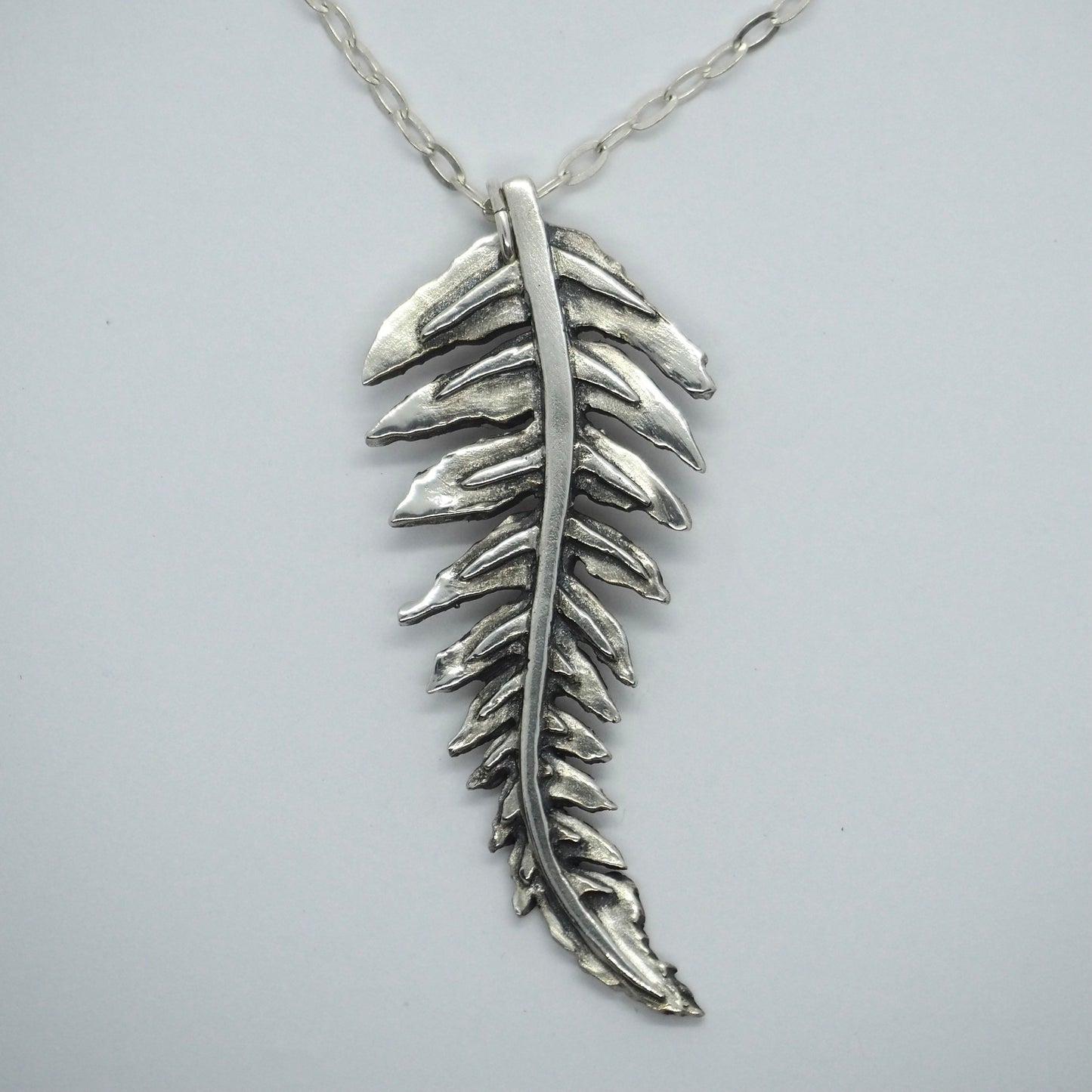 A gorgeous unique fern leaf handmade in eco friendly fine silver on a sterling silver necklace.