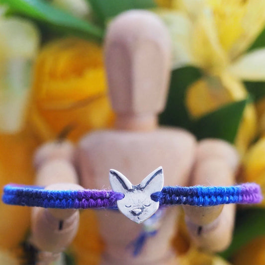 A wonderful deep blue and purple leather, sterling silver and cotton friendship bracelet with a tiny unique fine silver Siamese cat.