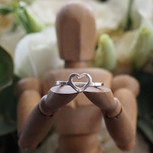 A perfectly simple tiny hand made sterling silver square wire heart ring.