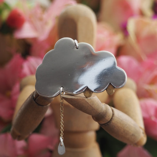 A simply adorable fine silver cloud pendant with tiny golden raindrops, one hung from 9ct gold chain hung on a sterling silver chain.