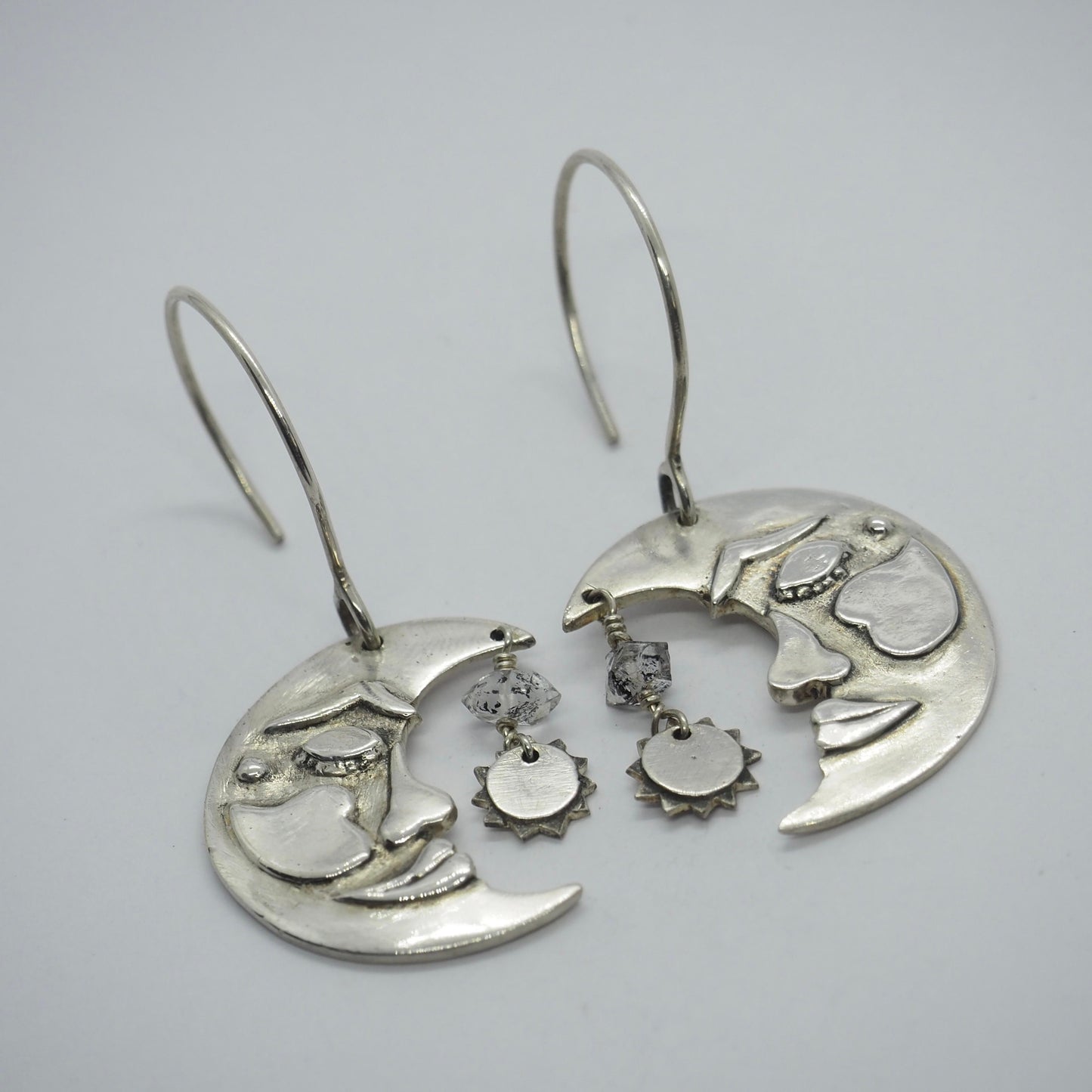 A lovely pair of handmade fine silver moon and sun earrings on sterling silver wires embellished with Herkimer diamonds.